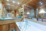 Step into luxury with this stunning bathroom featuring exquisite wooden paneling and a spa-like ambiance.