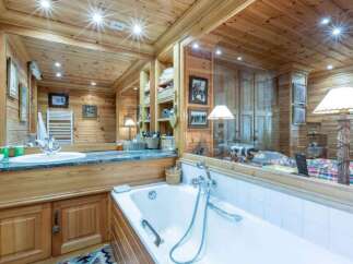 Step into luxury with this stunning bathroom featuring exquisite wooden paneling and a spa-like ambiance.