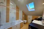 Discover the charm of this unique bathroom! Featuring a skylight that floods the space with natural light, this bathroom offers a bright and airy feel.