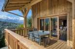 Experience luxury living with this stunning property featuring a spacious wooden deck and breathtaking mountain views.