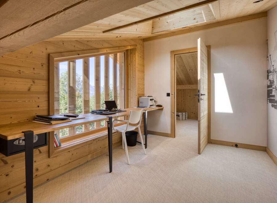 This stunning home office features a unique design with natural wood finishes and ample natural light.