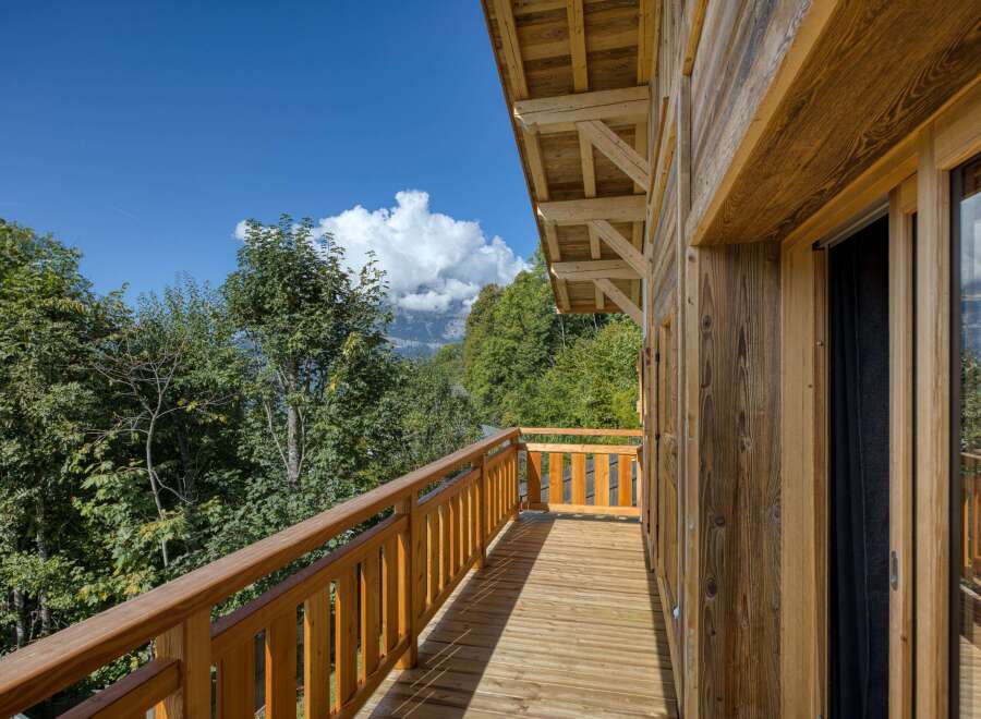 Enjoy breathtaking mountain views from this stunning wooden balcony.