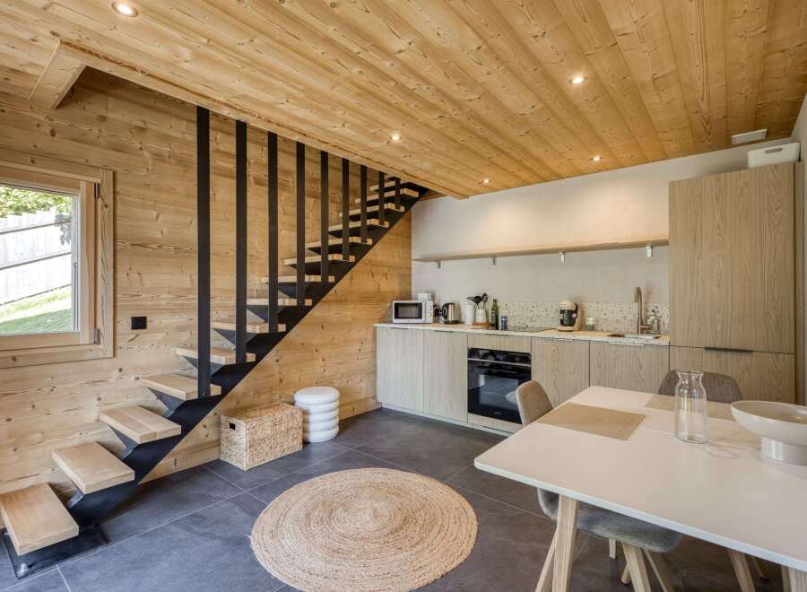This stunning property features a modern kitchen with sleek cabinetry and stainless steel appliances.