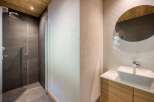 Step into a modern bathroom retreat, showcasing a sleek glass-enclosed shower and a stylish vanity area.
