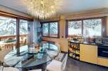 Experience the epitome of luxury living in this stunning property, featuring a sophisticated dining area with a breathtaking view of snow-covered landscapes.