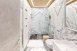 Step into luxury with this stunning bathroom, featuring exquisite marble accents and a modern design.