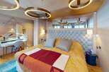 Experience luxury in this stunning bedroom, featuring a plush tufted headboard and elegant lighting fixtures.