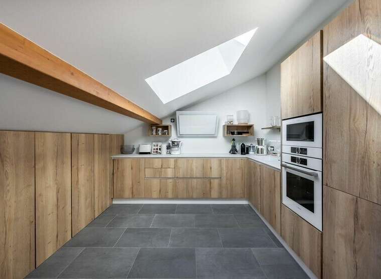 This stunning kitchen boasts a modern design with sleek wooden cabinetry, offering ample storage and a warm, inviting atmosphere.