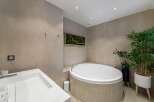 Indulge in luxury with this stunning bathroom featuring a modern design and high-end finishes.