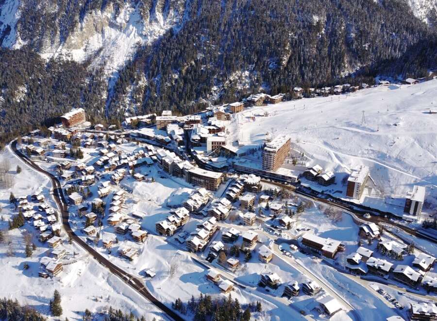Discover the charm of this snow-covered village nestled in the mountains.