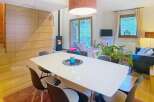 Discover this stunning property featuring a modern dining area with a sleek white table and stylish chairs.