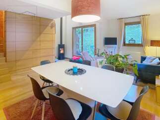 Discover this stunning property featuring a modern dining area with a sleek white table and stylish chairs.