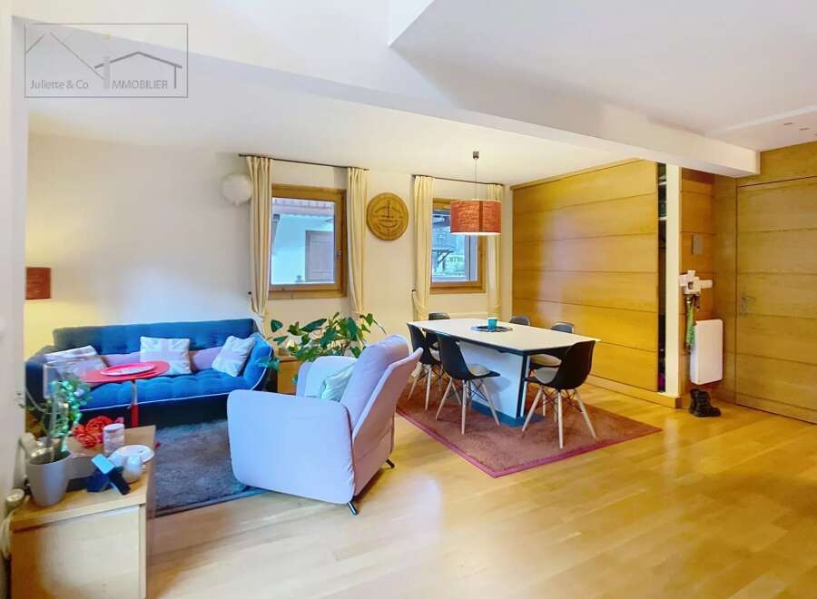 Discover this stunning property featuring a modern living space with a cozy blue sofa and a stylish pink armchair.