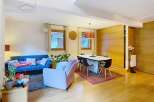 Discover this stunning property featuring a modern living space with a cozy blue sofa and a stylish pink armchair.