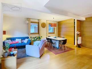Discover this stunning property featuring a modern living space with a cozy blue sofa and a stylish pink armchair.