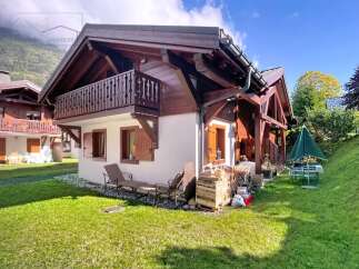 Discover the charm of this stunning chalet-style home, boasting a beautiful wooden facade and a welcoming balcony.
