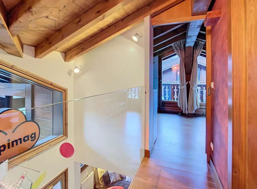 Discover the charm of this property with its stunning wooden beams and modern glass railing.