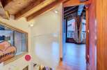 Discover the charm of this property with its stunning wooden beams and modern glass railing.
