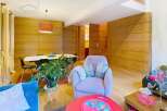 Discover this stunning property featuring a modern living space with a cozy armchair and a vibrant red coffee table.