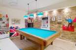 This stunning property boasts a spacious game room, perfect for entertaining and relaxation.