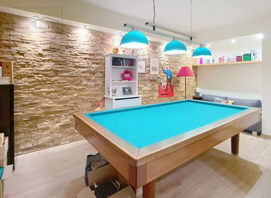 This stunning property boasts a unique entertainment space, perfect for hosting friends and family.