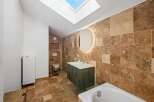 This stunning bathroom boasts a luxurious design with natural stone tiles and a modern vanity.