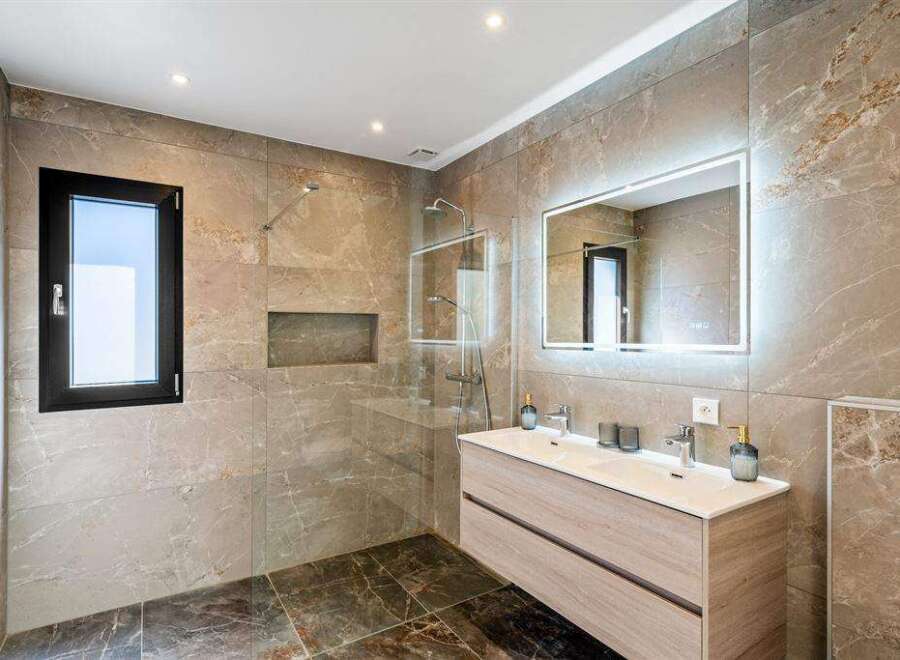 Step into luxury with this stunning bathroom featuring a sleek, modern design.
