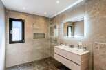 Step into luxury with this stunning bathroom featuring a sleek, modern design.
