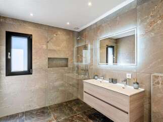 Step into luxury with this stunning bathroom featuring a sleek, modern design.