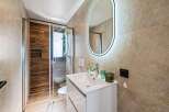 Step into a modern bathroom oasis, featuring a sleek white vanity and a stylish, illuminated mirror.