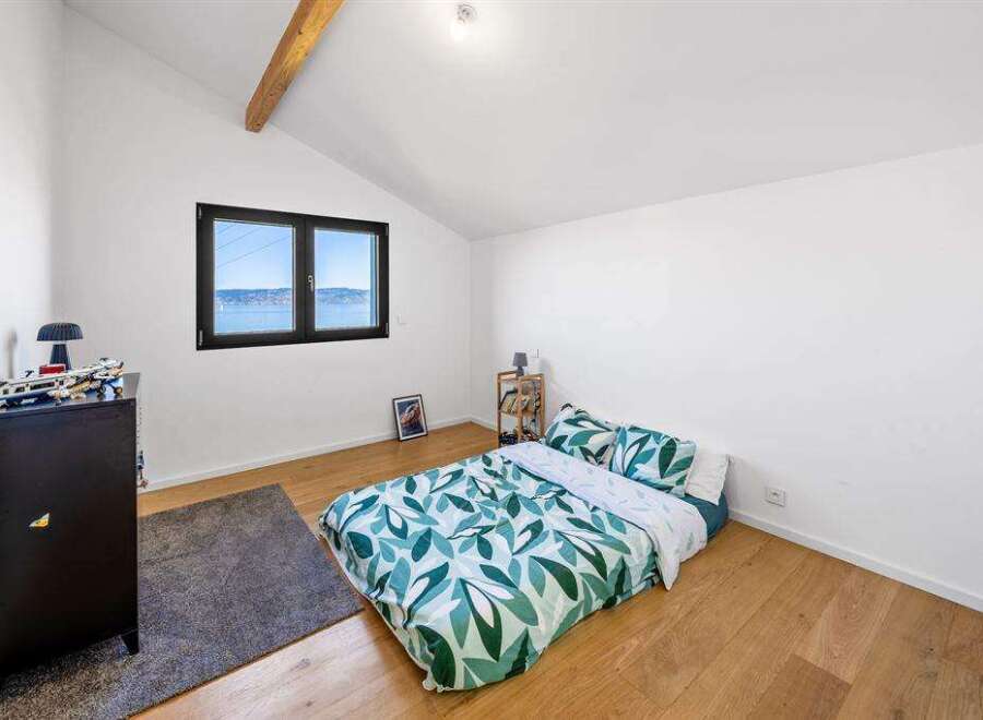 This bright and airy bedroom offers a serene retreat with its minimalist design and natural light.