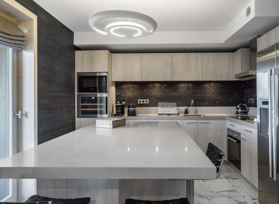 This modern kitchen boasts a sleek design with a large island, perfect for entertaining.