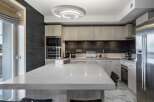 This modern kitchen boasts a sleek design with a large island, perfect for entertaining.
