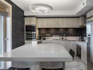 This modern kitchen boasts a sleek design with a large island, perfect for entertaining.