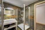 Step into luxury with this stunning bathroom featuring a modern glass shower enclosure and elegant tile work.