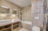 Step into this luxurious bathroom featuring a sleek design and modern amenities.