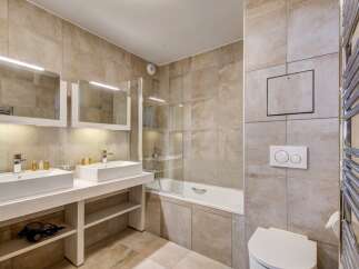 Step into this luxurious bathroom featuring a sleek design and modern amenities.