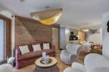 Experience luxury living in this stunning property, featuring a beautifully designed living space with a cozy sofa and stylish armchairs.