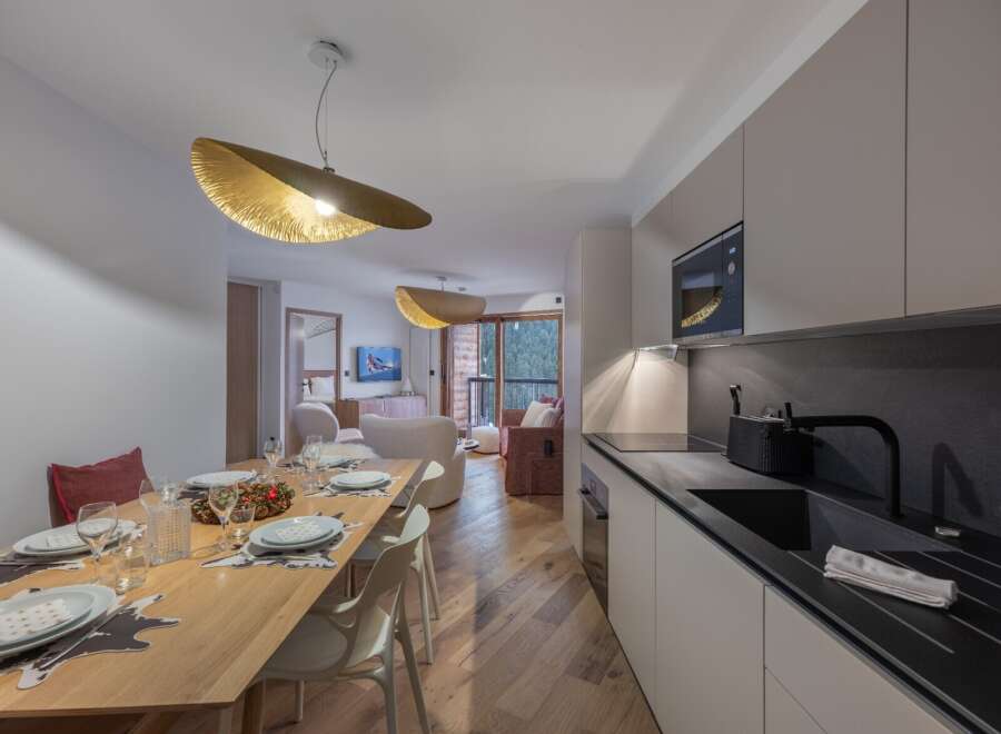 Experience luxury living in this stunning property, featuring a modern kitchen with sleek countertops and high-end appliances.