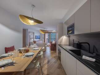 Experience luxury living in this stunning property, featuring a modern kitchen with sleek countertops and high-end appliances.