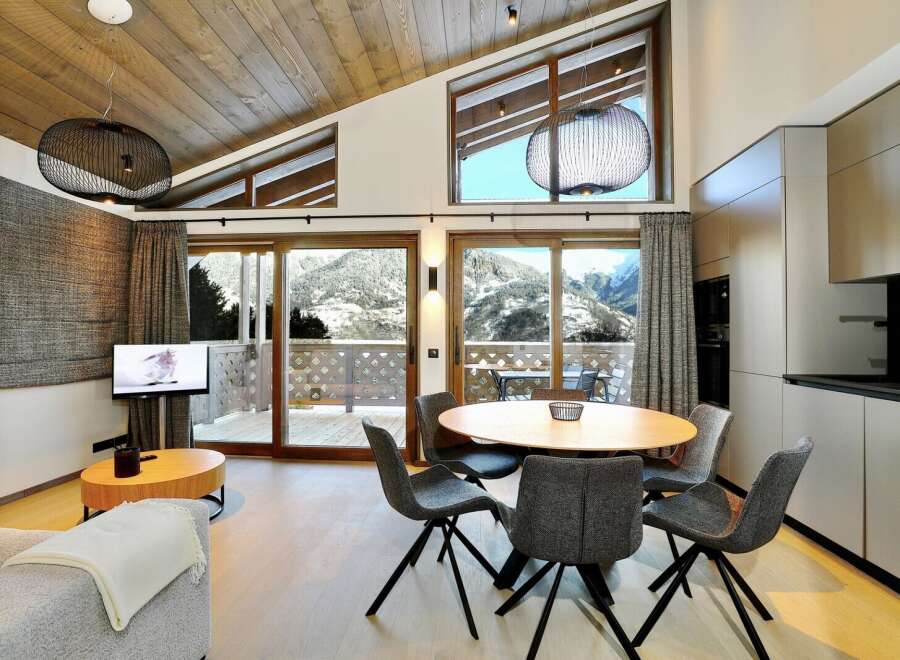 Experience luxury living in this stunning property, featuring a modern kitchen and a cozy living area.