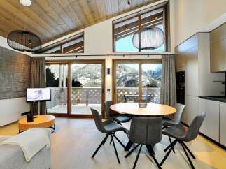 Experience luxury living in this stunning property, featuring a modern kitchen and a cozy living area.