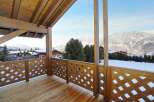 Enjoy breathtaking mountain views from this stunning wooden balcony.