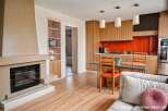 Discover modern living in this stylish property featuring a cozy fireplace and a sleek kitchen with stainless steel appliances.