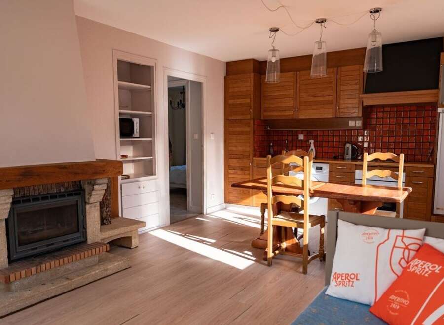 Discover the charm of this inviting property, featuring a cozy fireplace and a well-equipped kitchen.