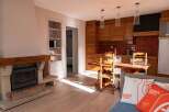 Discover the charm of this inviting property, featuring a cozy fireplace and a well-equipped kitchen.