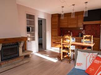 Discover the charm of this inviting property, featuring a cozy fireplace and a well-equipped kitchen.