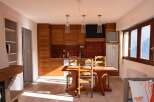 Discover this charming property featuring a cozy kitchen with wooden cabinets and a dining area perfect for gatherings.