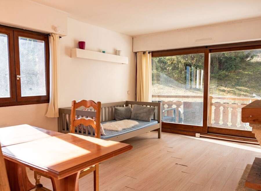 This charming property features a cozy living space with a comfortable daybed, perfect for relaxation.