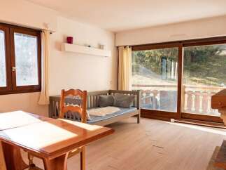 This charming property features a cozy living space with a comfortable daybed, perfect for relaxation.